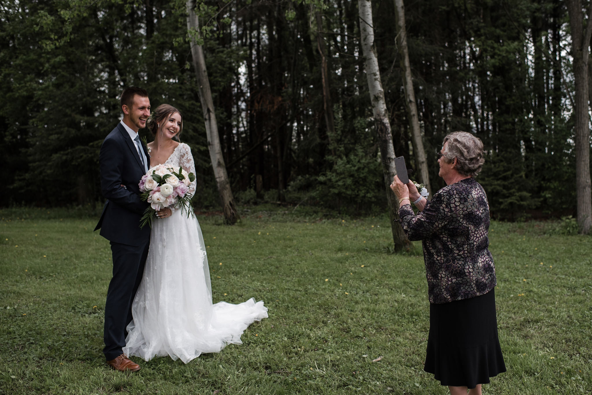 165-candid-moment-grandma-wedding-couple-forest.jpg