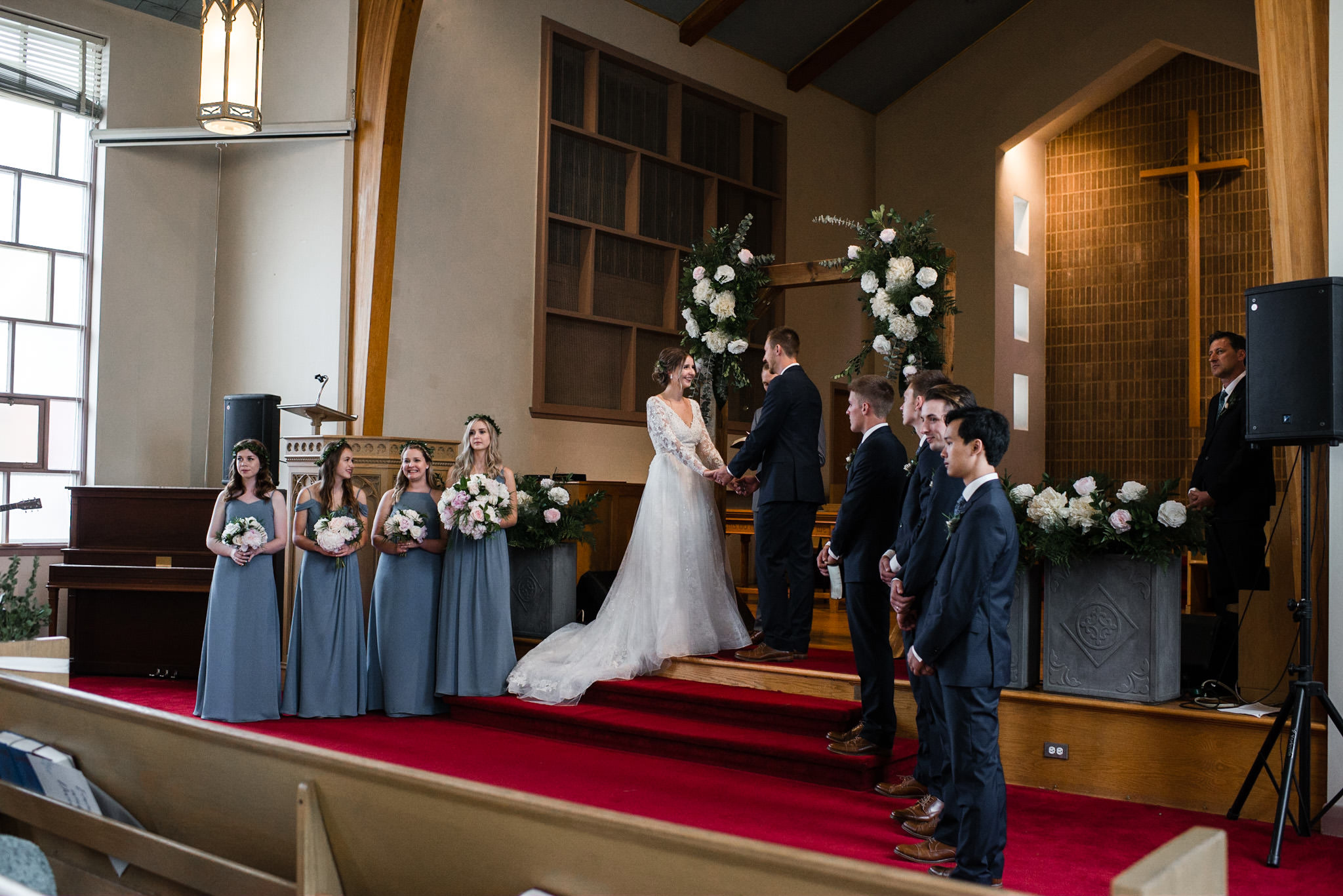 188-bride-groom-worship-toronto-church-wooden-arch-flowers.jpg