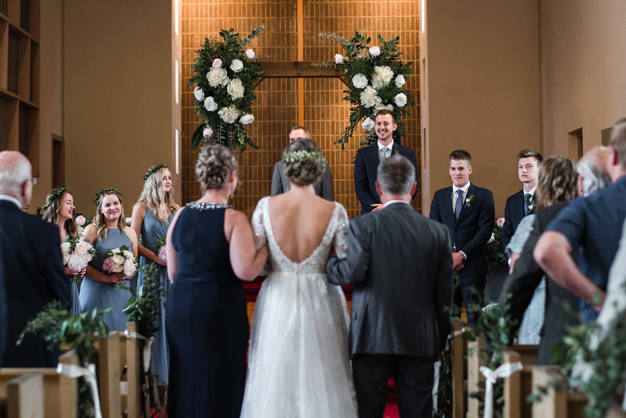 192-groom-reaction-seeing-bride-down-aisle-wedding-ceremony-wooden-arch.jpg
