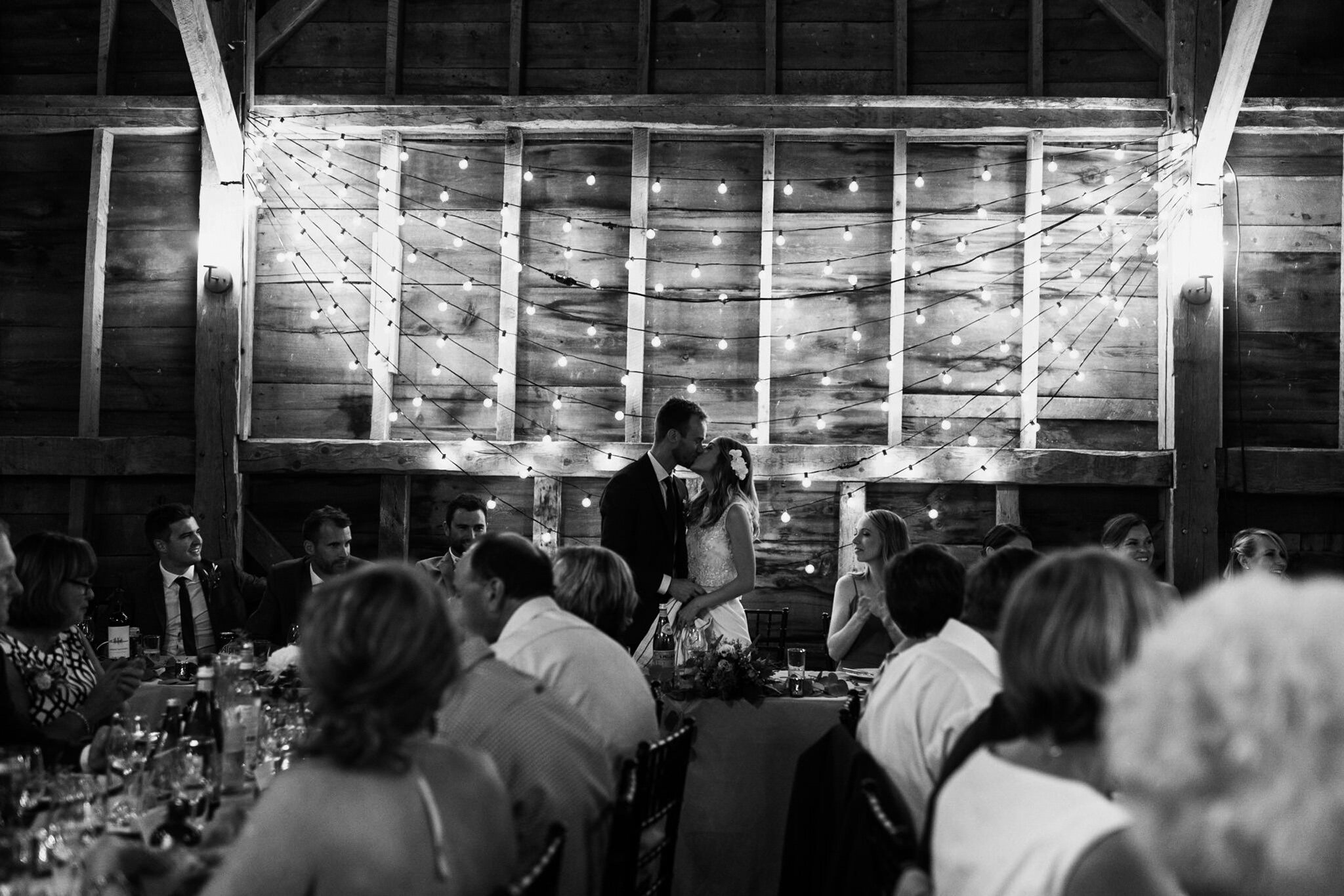 093-bride-groom-string-lights-reception-wedding-photos-speech-reactions.jpg