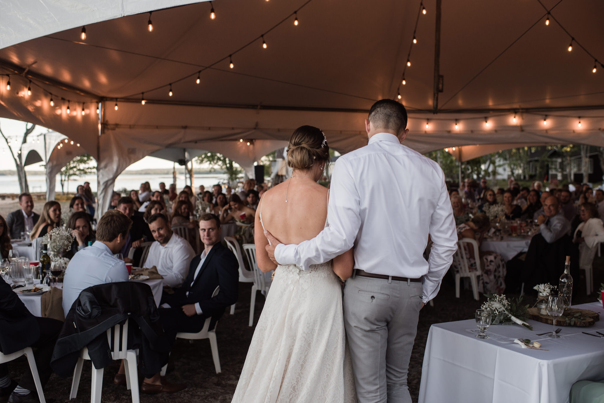 573-bride-groom-speech-tent-string-lights-reception-wedding-cottage.jpg