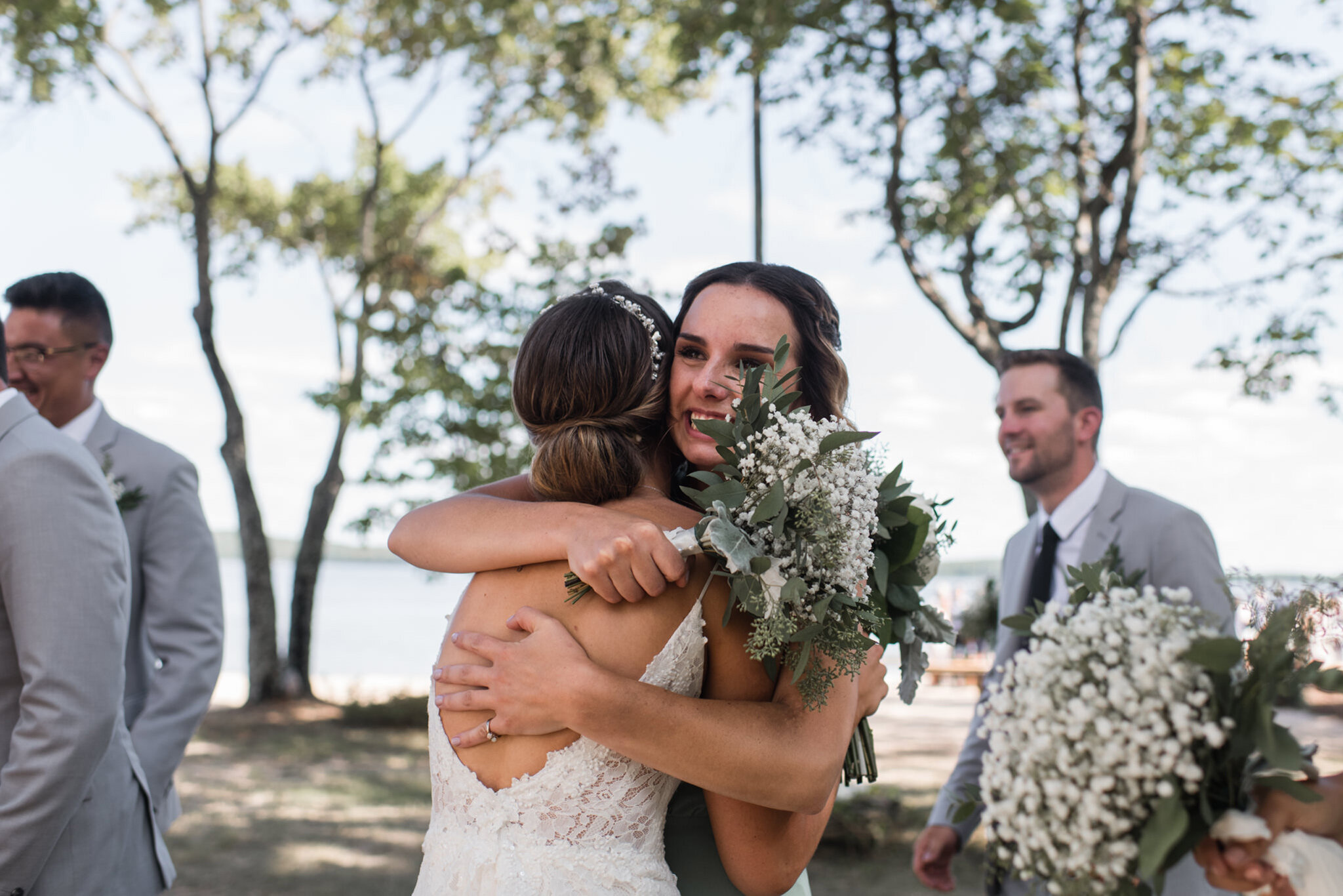 597-bridesmaids-post-ceremony-reactions-hugs-documentary-cottage-lake-wedding.jpg